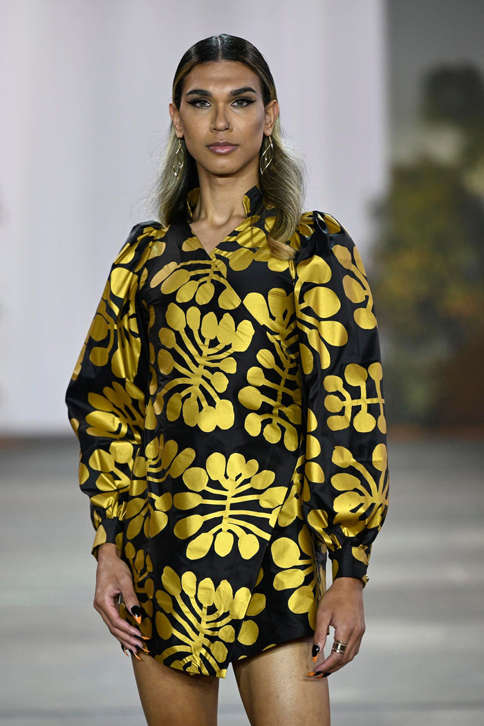 Wrap around gold on black mini dress in Mitjili Napurrula’s Watiya Tjuta silk OSSOM x Ikuntji Artists AAFW '23